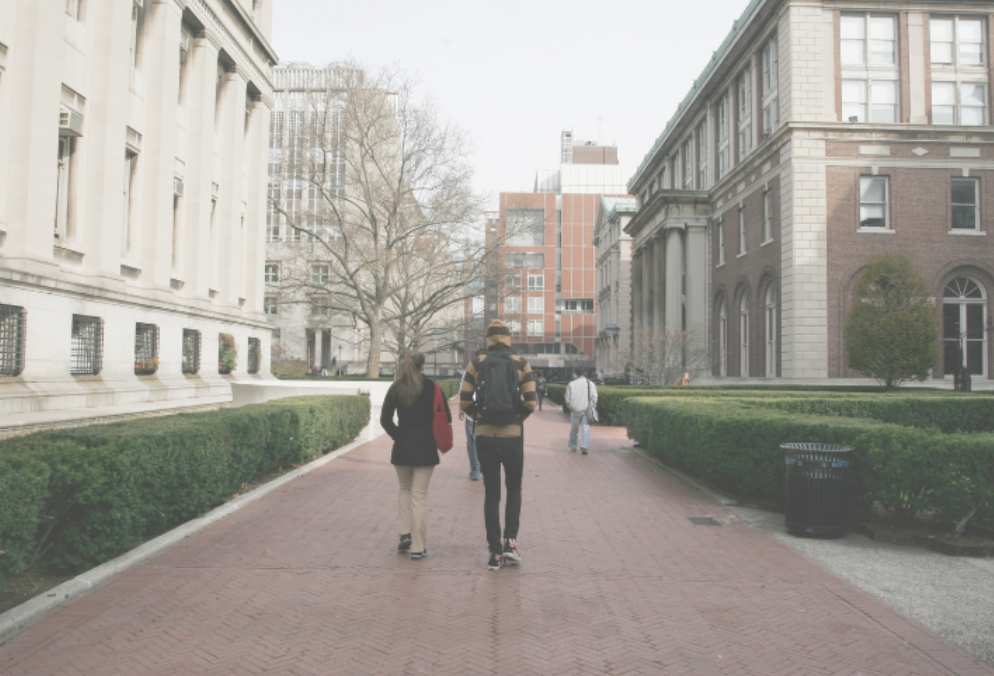Two students walking on their university campus. Representing individuals who could benefit from therapy for college students in Brooklyn. With online therapy you can get support finding your path from anywhere in New York.