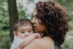 Mother holding her baby in Manhattan. Therapy helped her with her pregnancy journey.