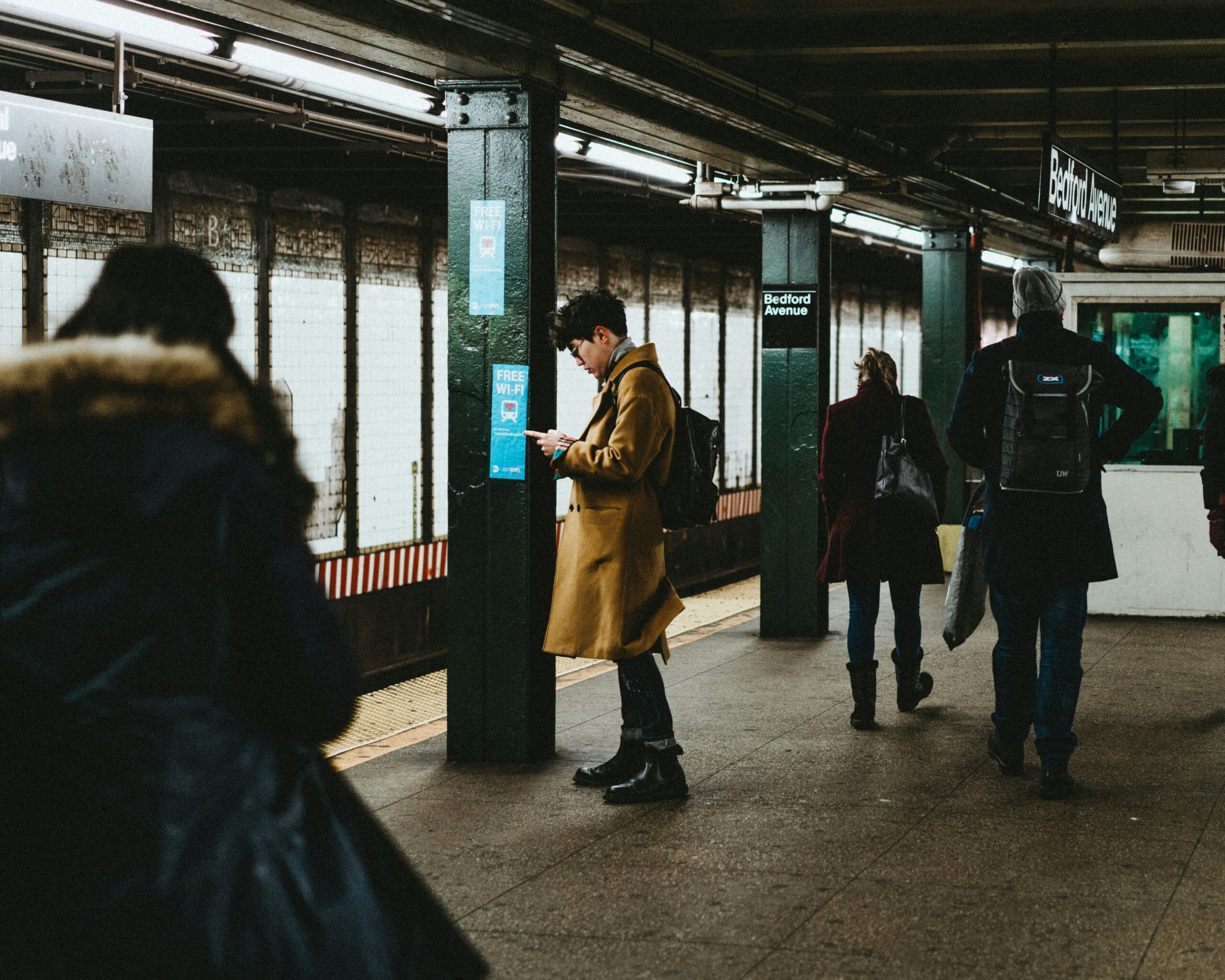 Person standing in a Manhattan subway station looking for new ways to manage their anxiety. Freedom from anxiety is possible with our trained therapist tips and tricks.