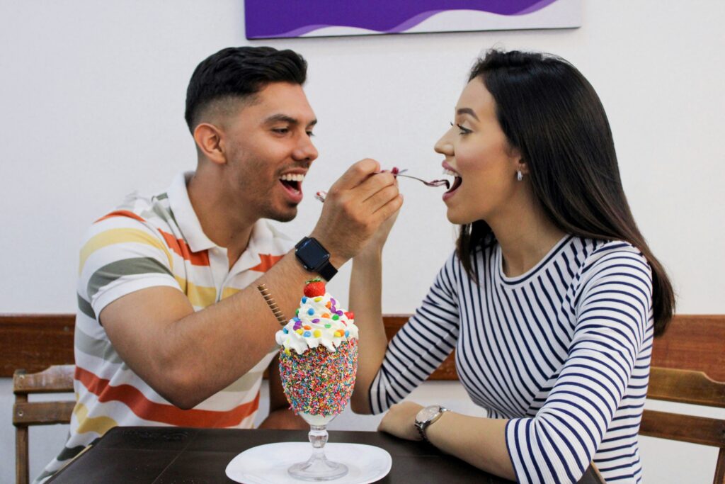 Brooklyn couple eating ice cream together, having fun and bonding over cultural similarities. 