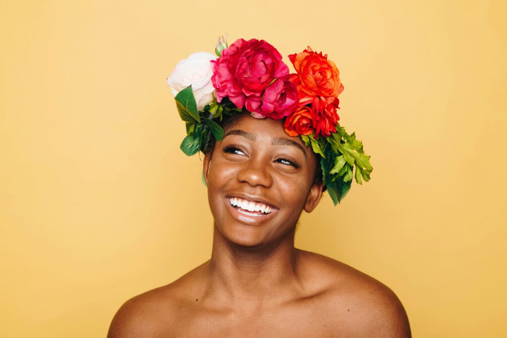 Brooklyn woman with a flower crown, smiling because she has set boundaries with the relationships in her life. 