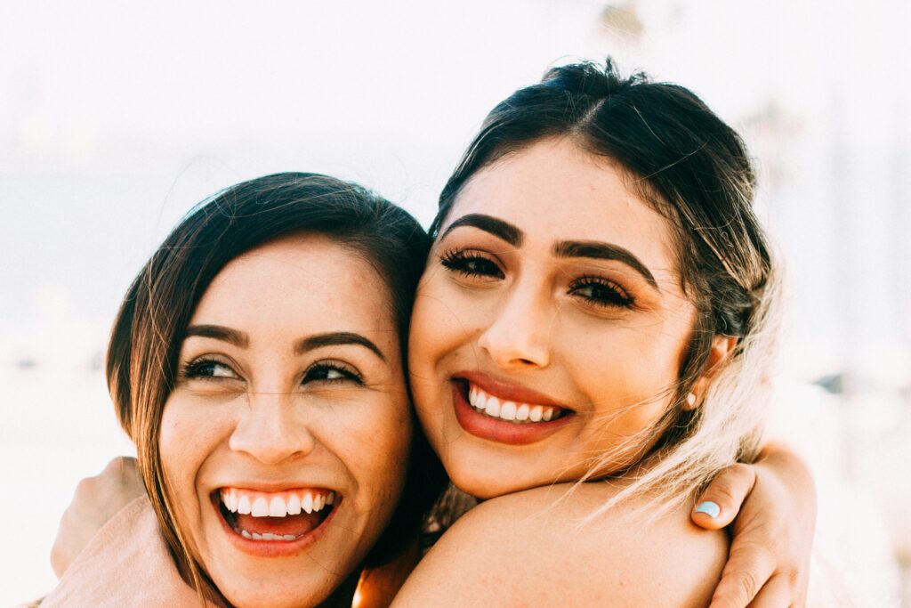 Two woman smiling after a successful therapy session in Brooklyn. Eating disorder recovery is possible with acceptance and respect between the client and therapist. 