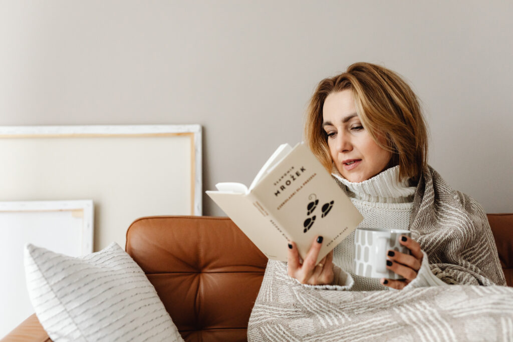 Woman in New York City reading with a cup of coffee in in her hand. Eating disorders can be lifelong, but therapy can help. 