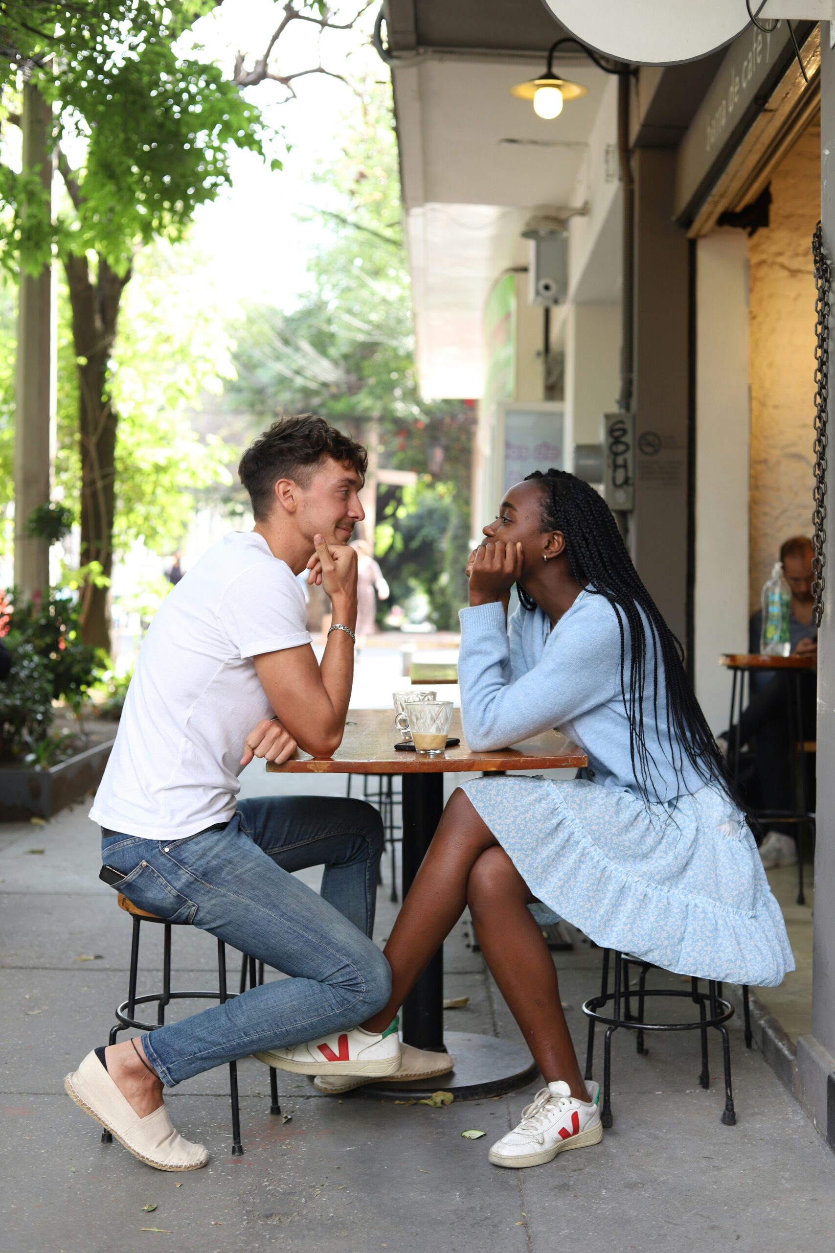 Manhattan couple sitting at a sidewalk cafe enjoying each other. Insecurity in your relationship can be overcome with these tips.