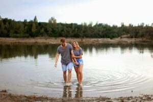 Manhattan couple holding hands in a lake. Communication is an important part of dating. Learn to improve your communication skills.