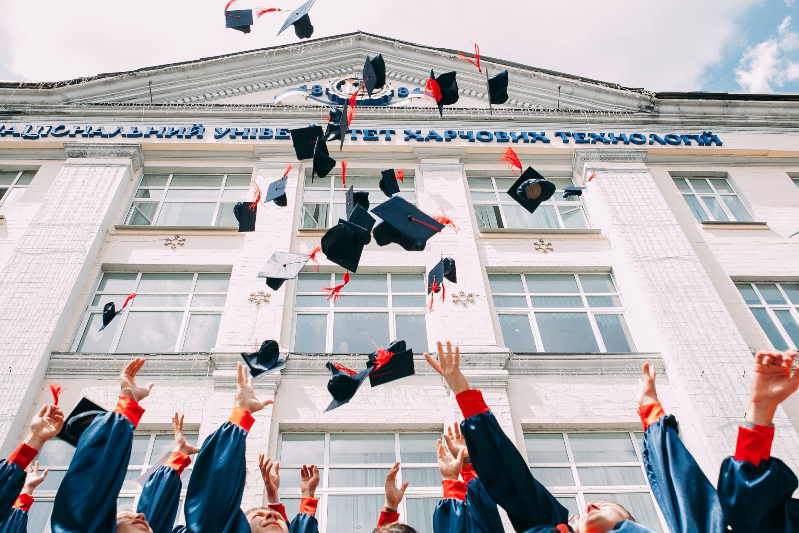 New York City graduates throwing their hats in the air to celebrate. Academic stress is part of college. But therapy can help you manage.