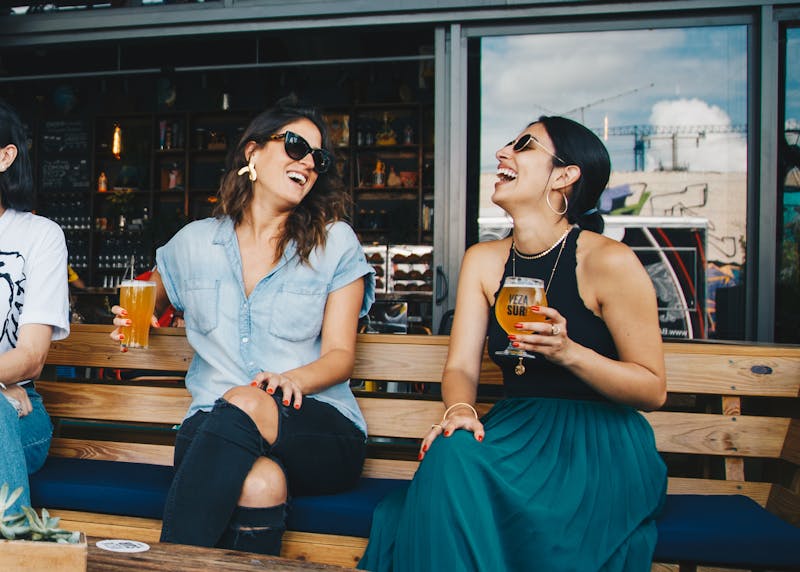 Manhattan girlfriends grabbing a drink after work in the summer. 