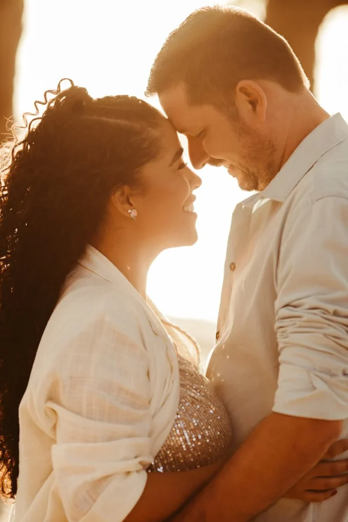 Manhattan couple staring into each others eyes in an embrace with a sunset in the background. Couples counseling can help improve your relationship. 