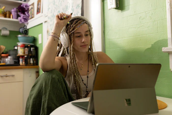 Brooklyn college student listening to music while studying. The transition to college is tough, but therapy can help. 