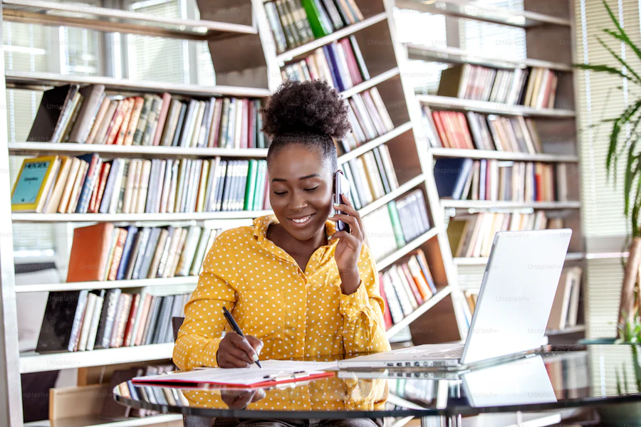 Manhattan woman smiling as she works on her computer because she created a work-life balance.