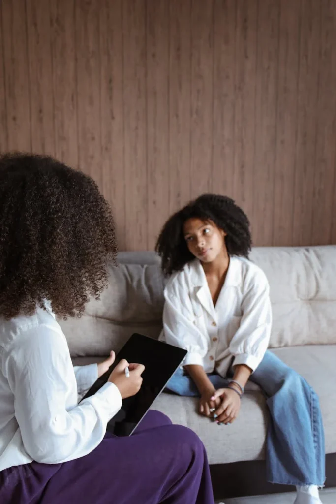 Female in therapy, deep in thought.