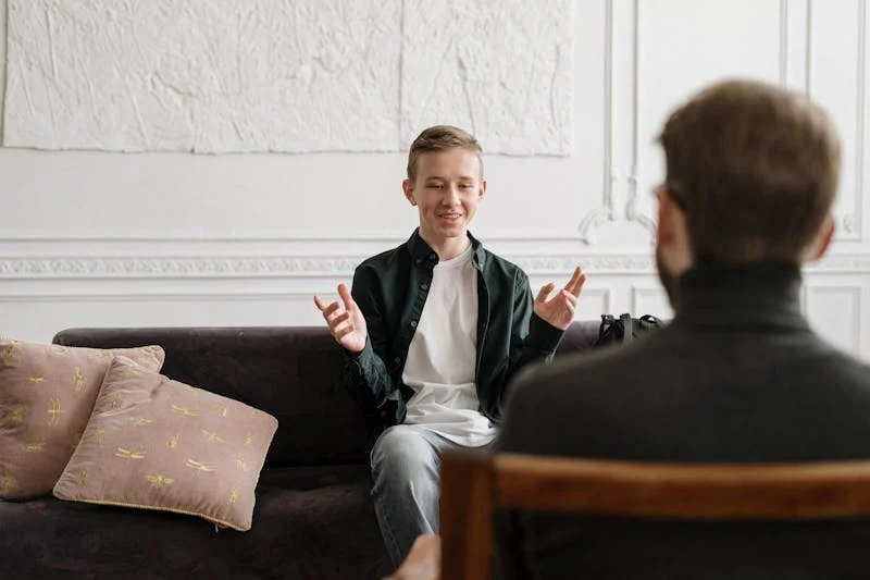 Client in therapy talking sitting on couch.