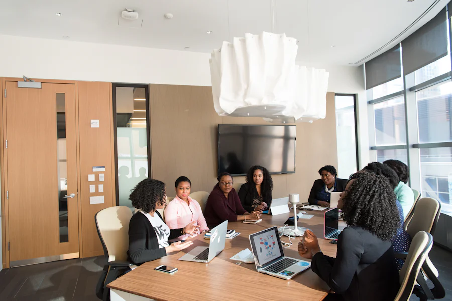 Women sitting around a table in their business meeting. They are supporting each other in the workforce.