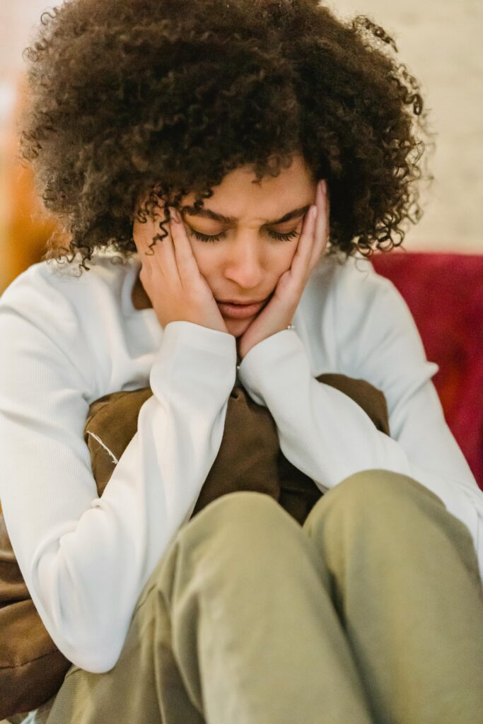 Stressed woman with her head in her hands. She is experiencing EMDR.