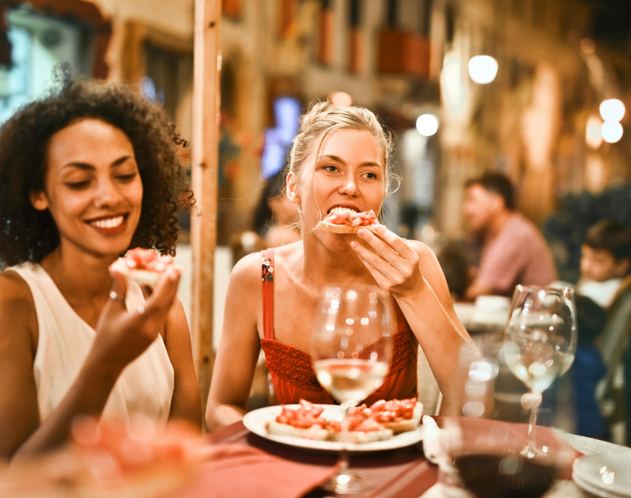 Two women eating together happy.