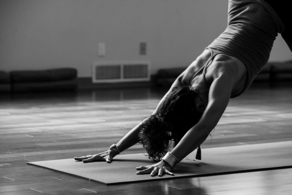 Black and white image of a woman stretching.