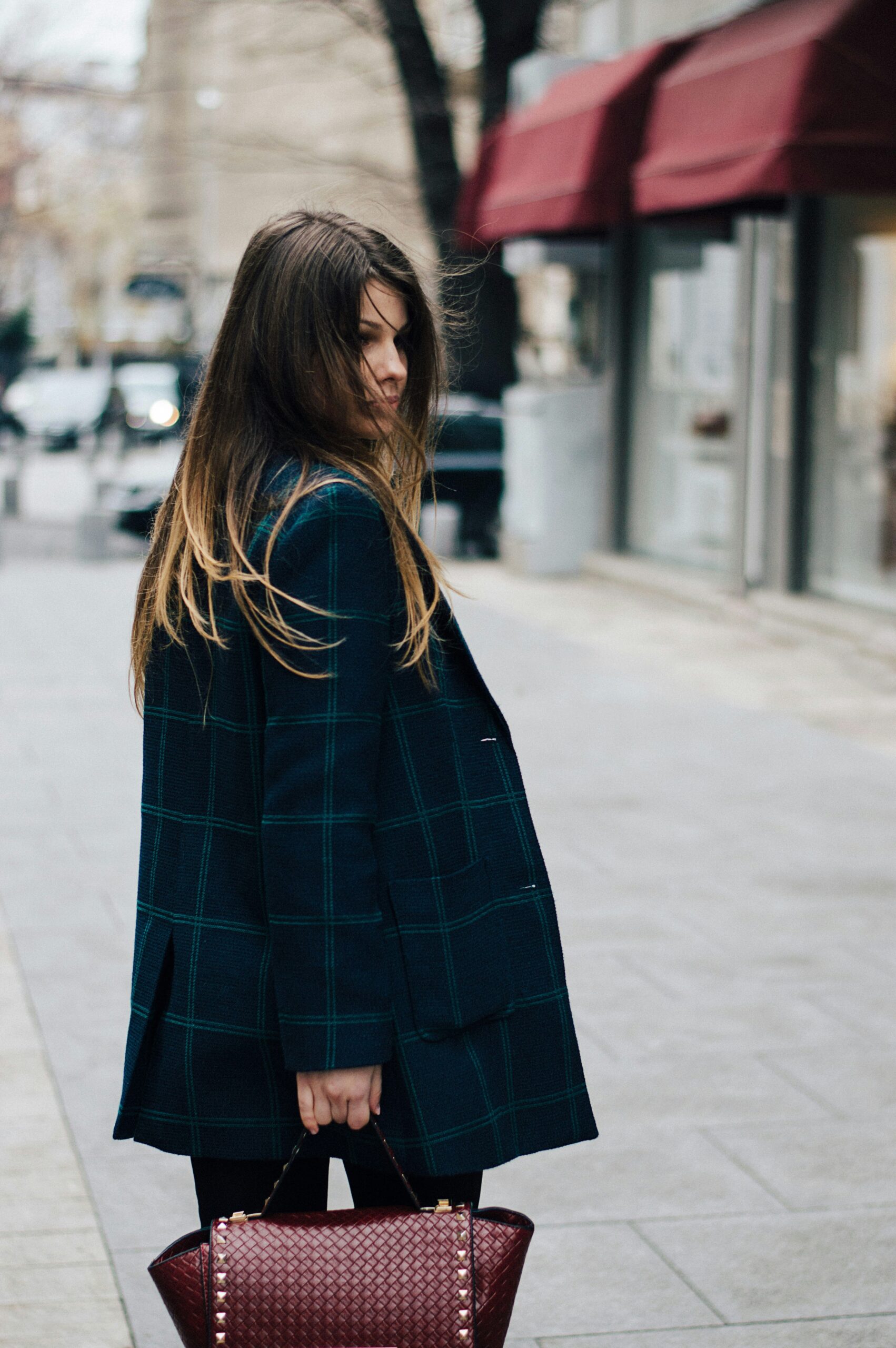 Woman walking in city with a bag.