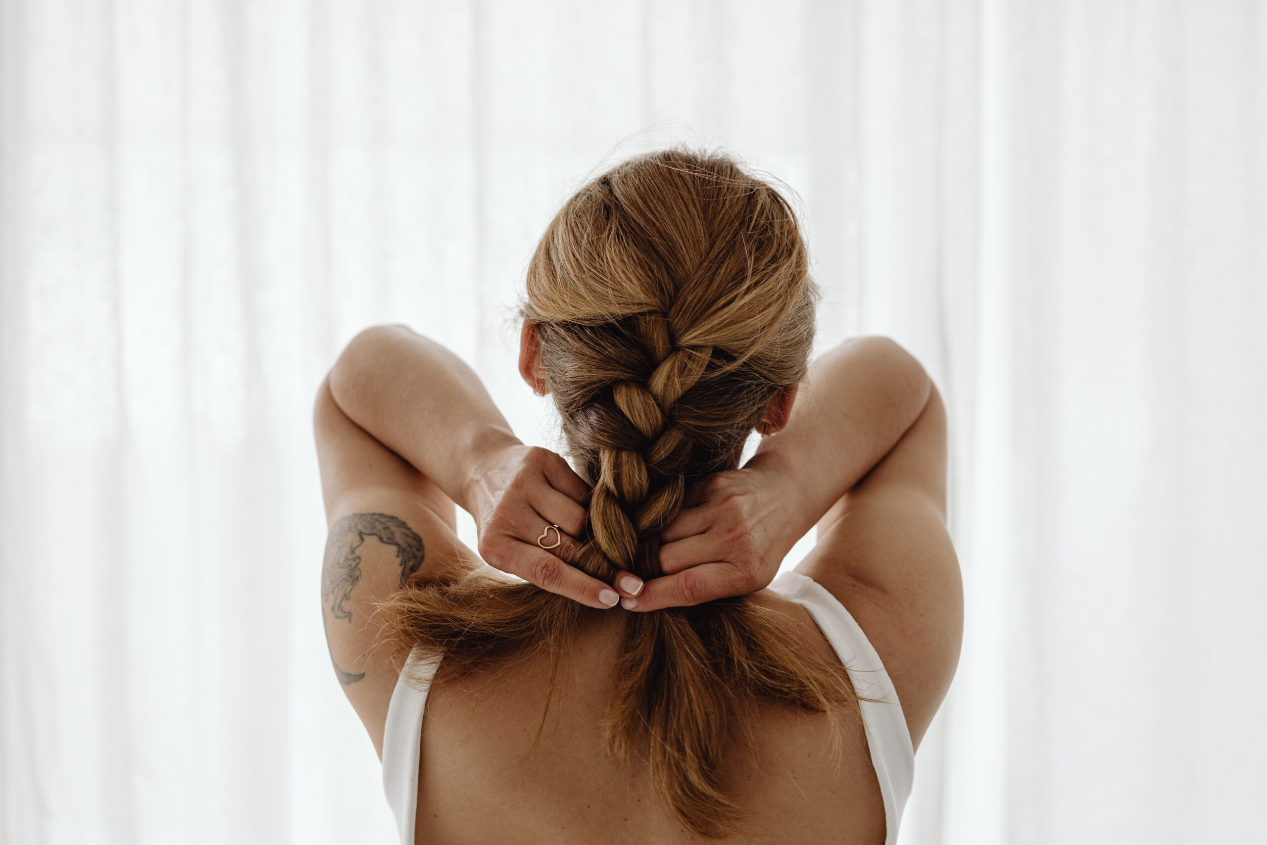 Women braiding her hair.