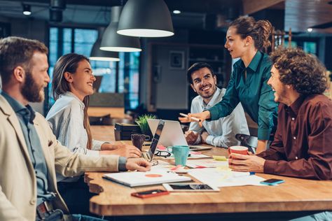 People working together and happily collaborating. They are networking and building connections.