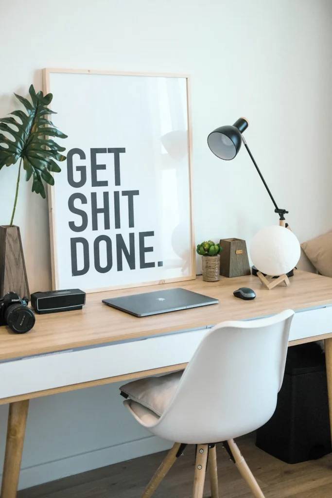 Work desk with "Get Shit Done" Poster.