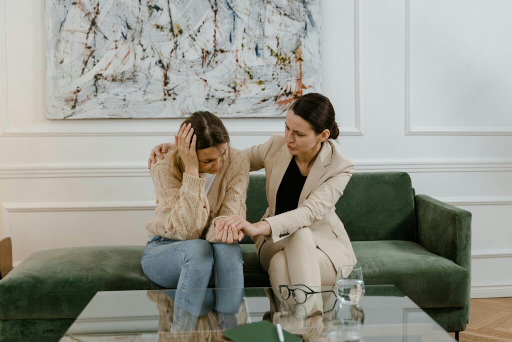 Therapist comforting her client in session.