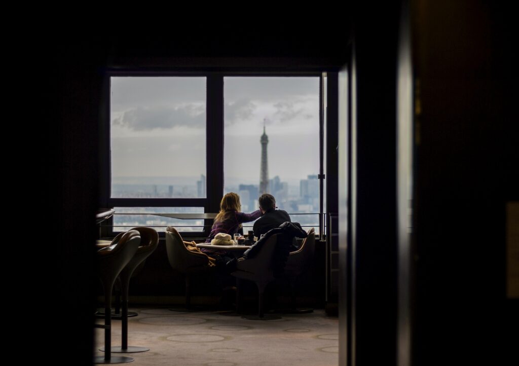 Couple eating out together looking out the window.