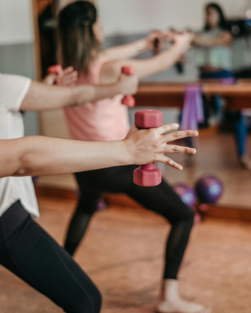 Holding weights in an exercise class.