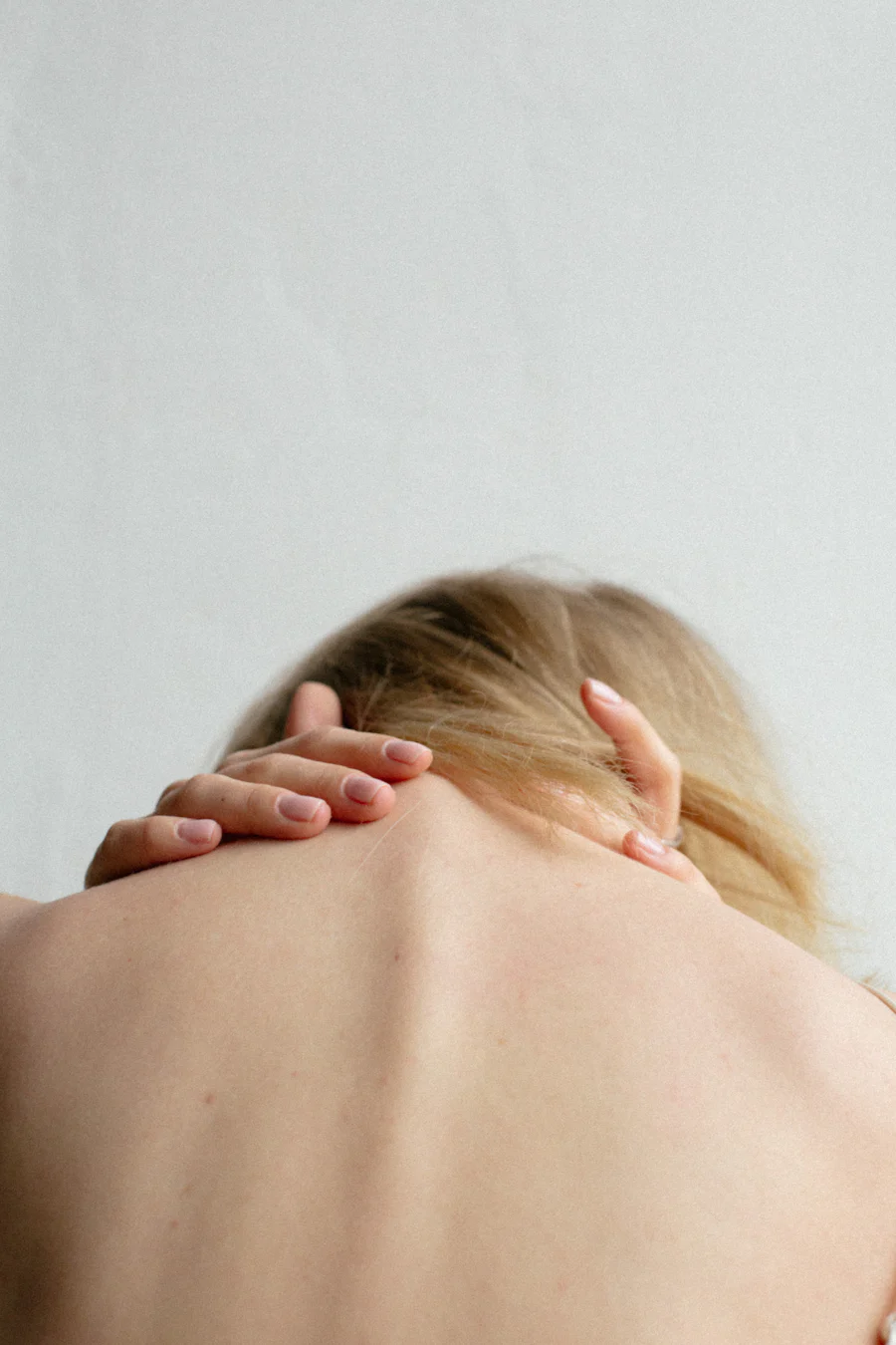 Anxious women with hands around her back.