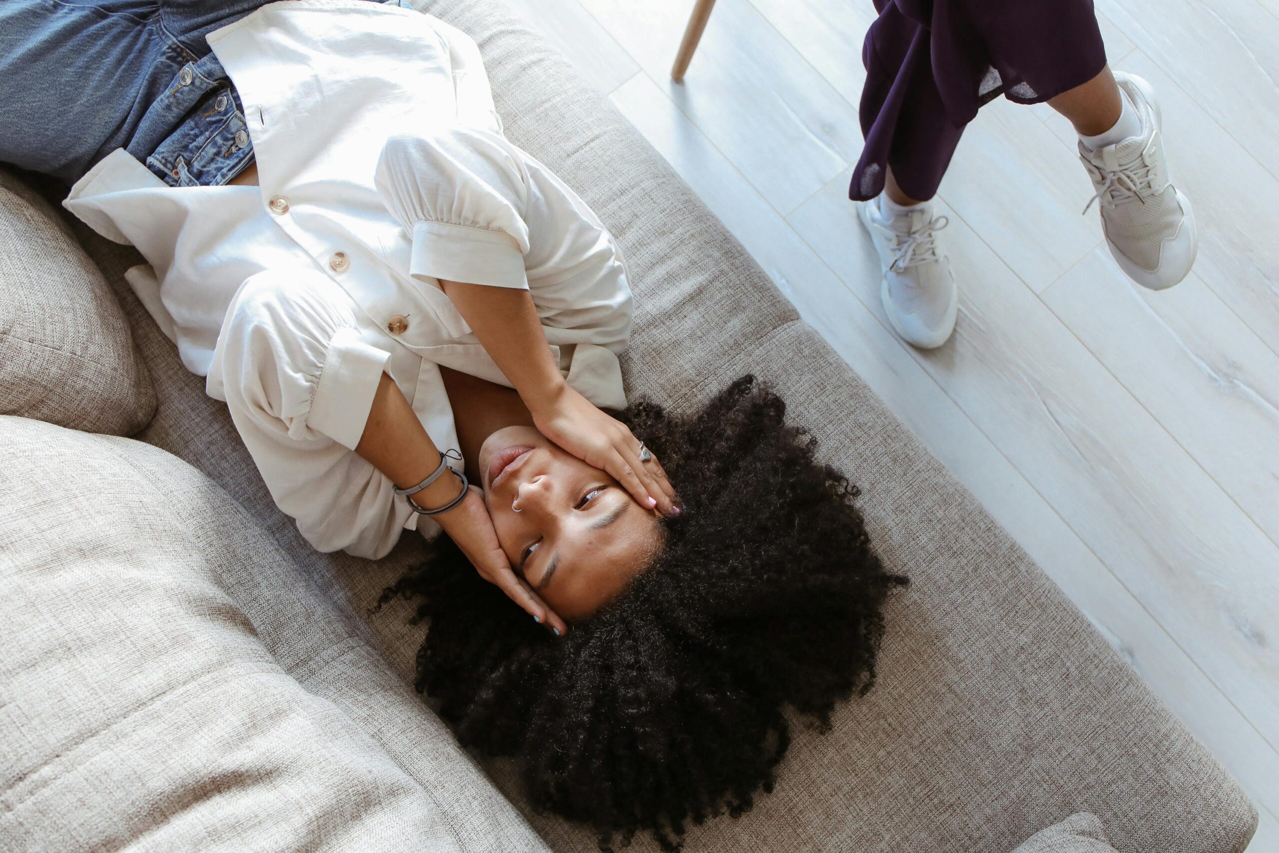 Stressed woman laying on couch during therapy.