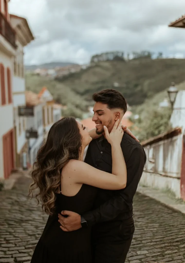Couple smiling and looking at each other outside.