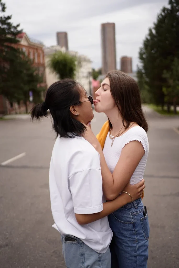 Couple taking silly picture, one licking the other.