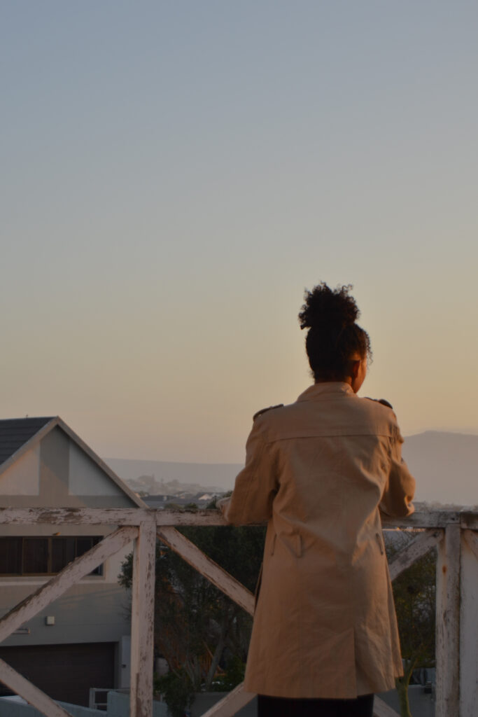 Woman outside looking into the sunset.