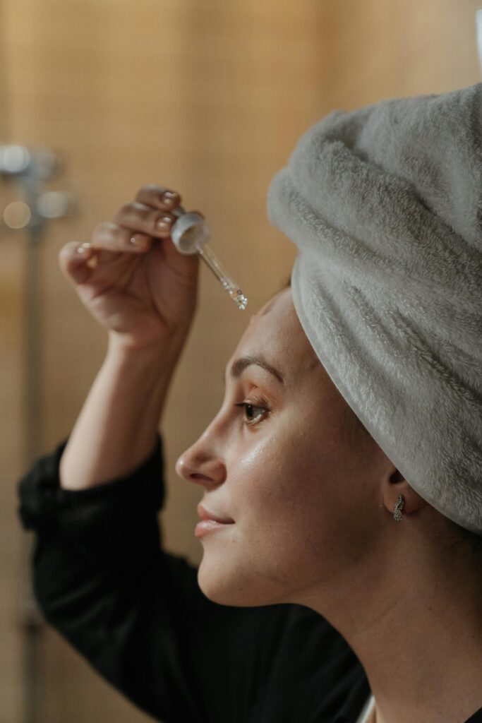Woman out of shower doing skincare and self love.