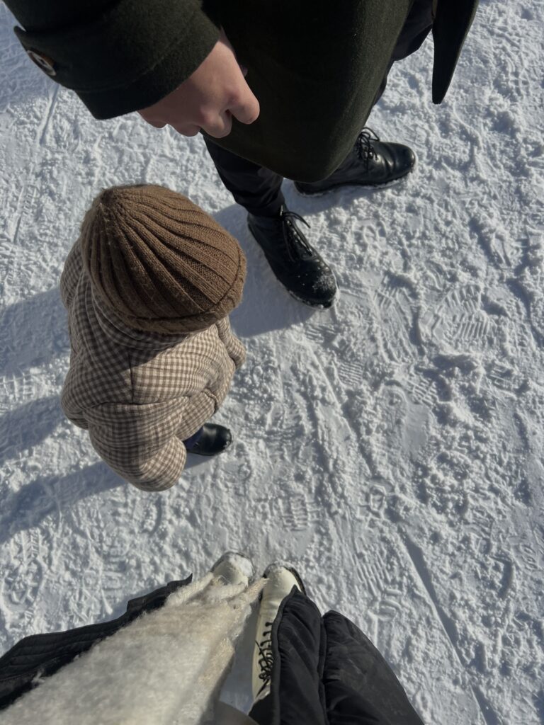 Parents and child walking in the snow