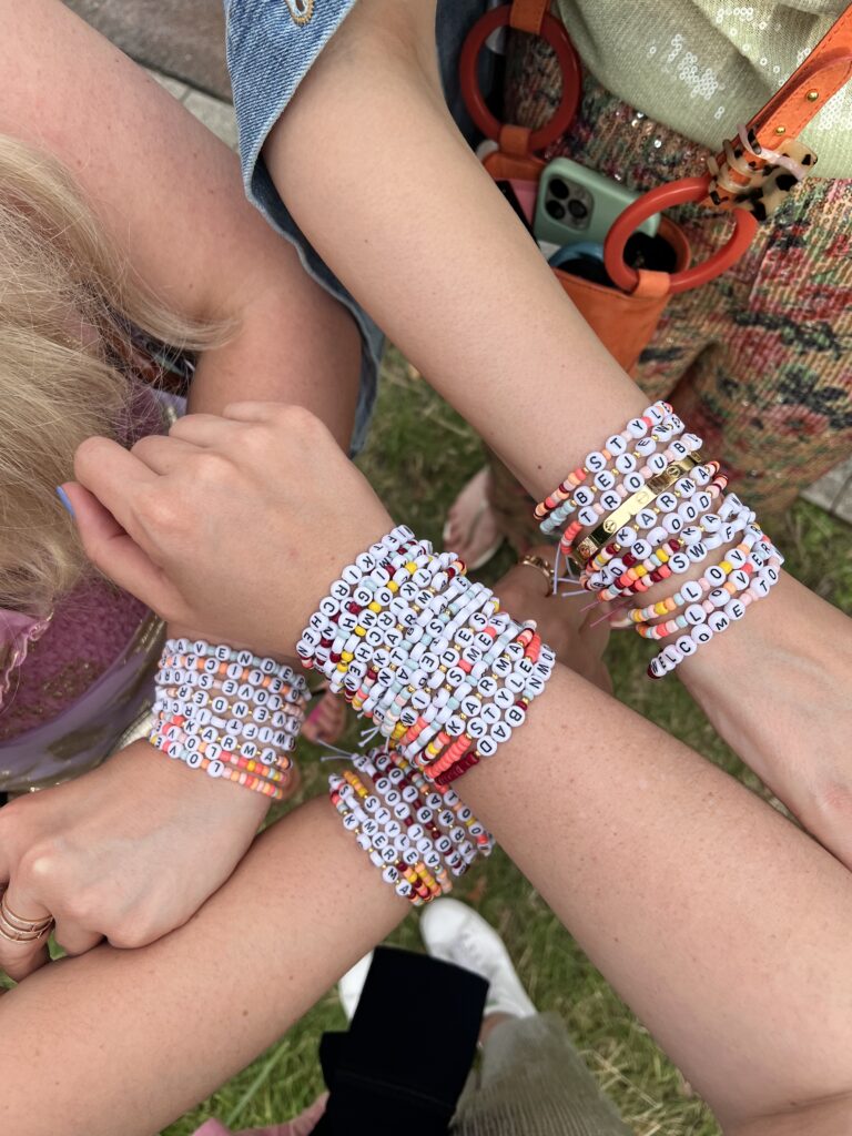 Friends wearing friendship bracelets together.