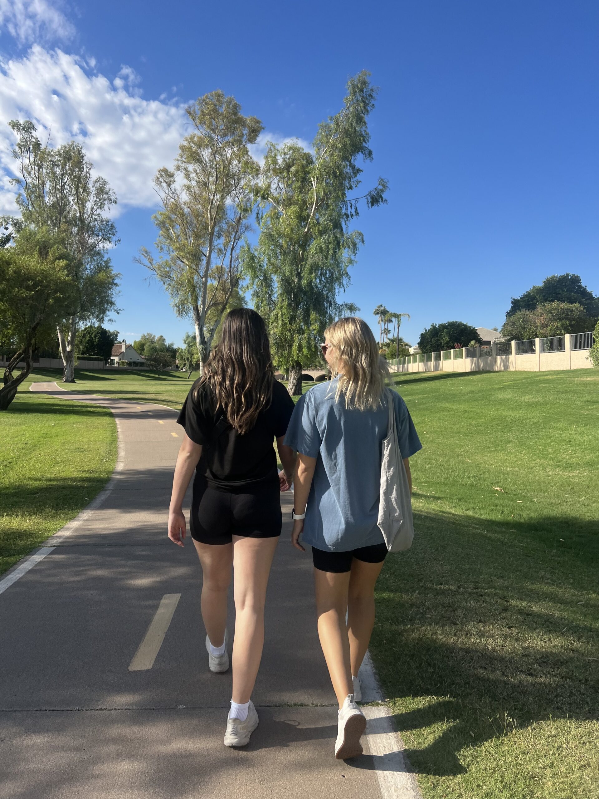 Two friends walking together outside.