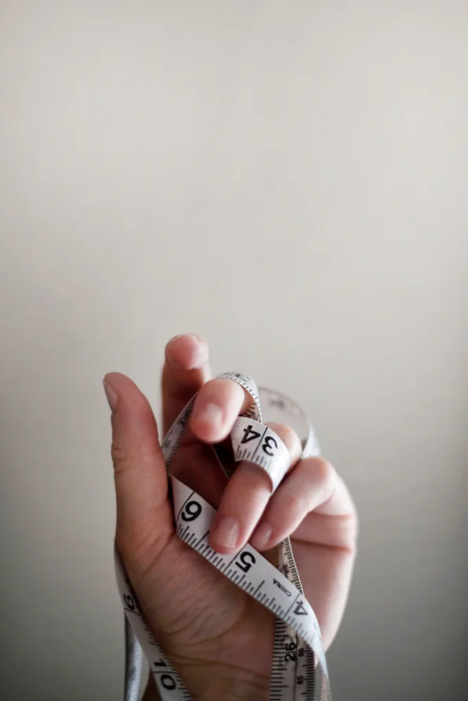 Tape measure wrapped around a hand.