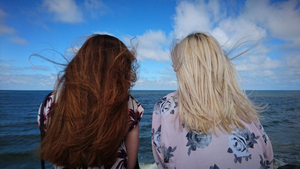 Two friends looking out at the water.