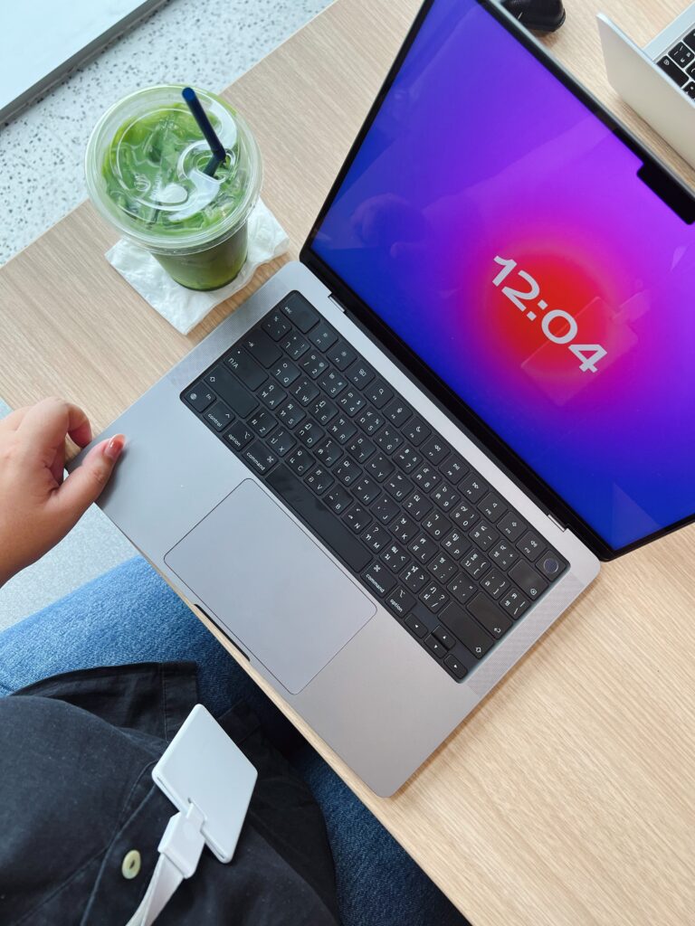 Computer and matcha at desk.