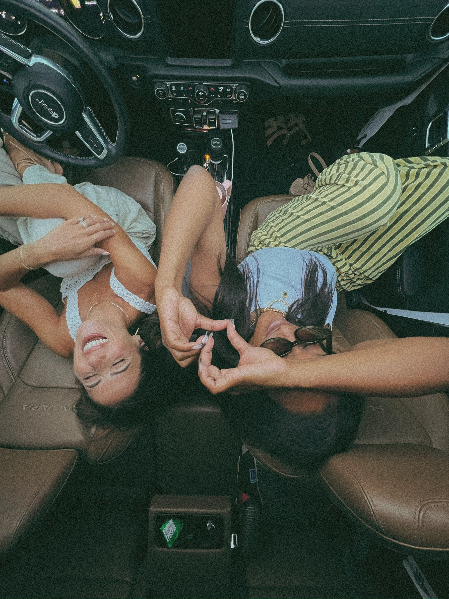 Friends laughing in the car together.