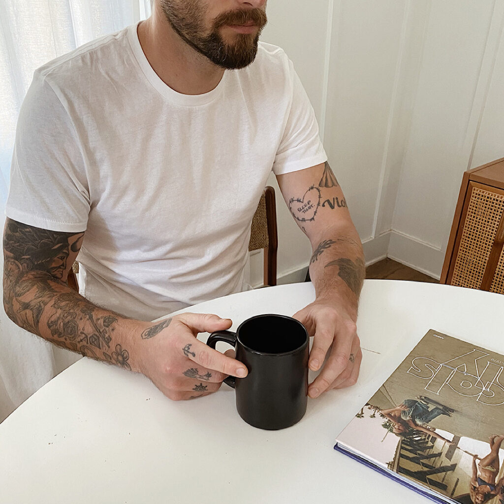 Man drinking coffee at a table.