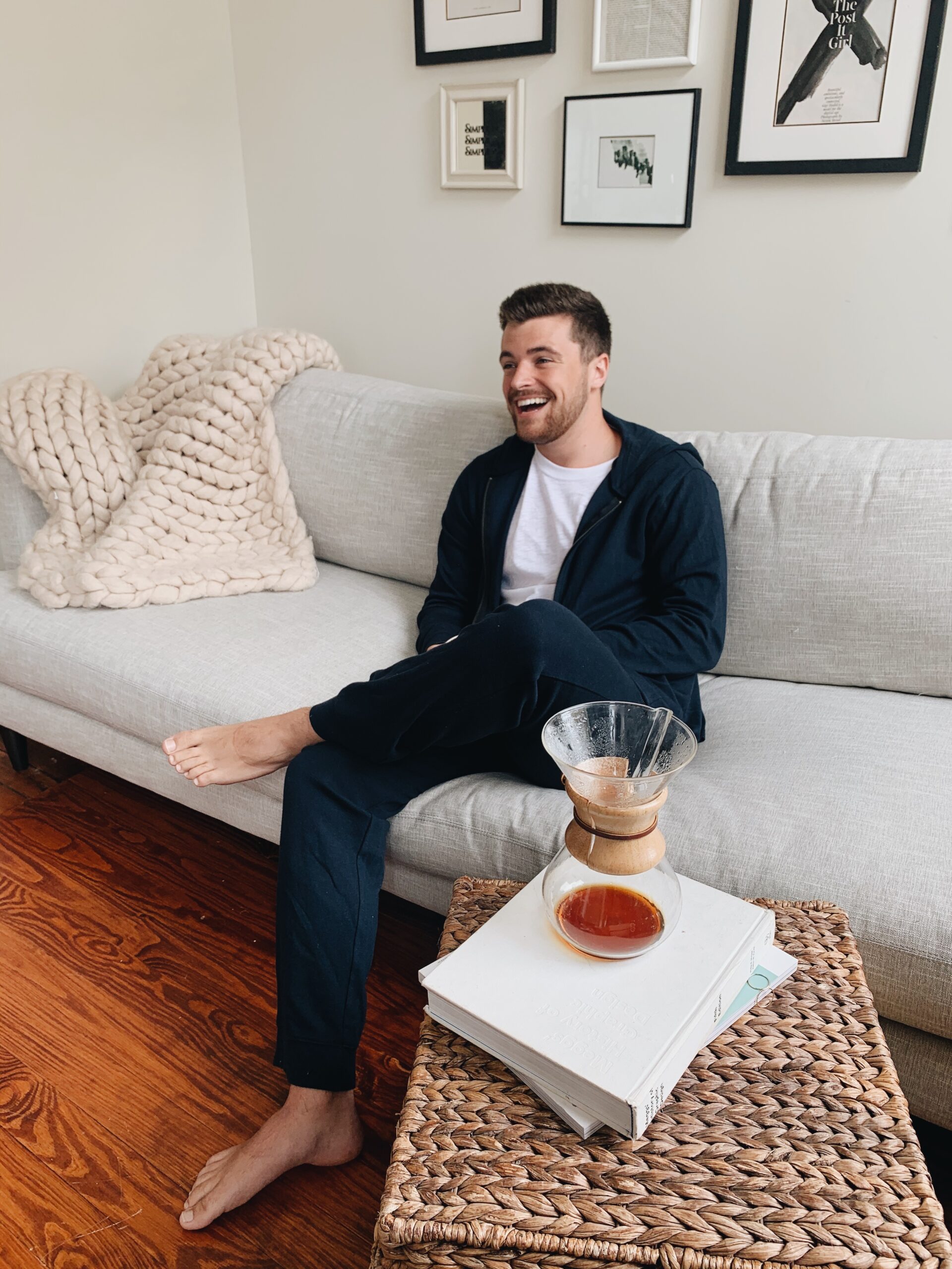 Man laughing on the couch in therapy.