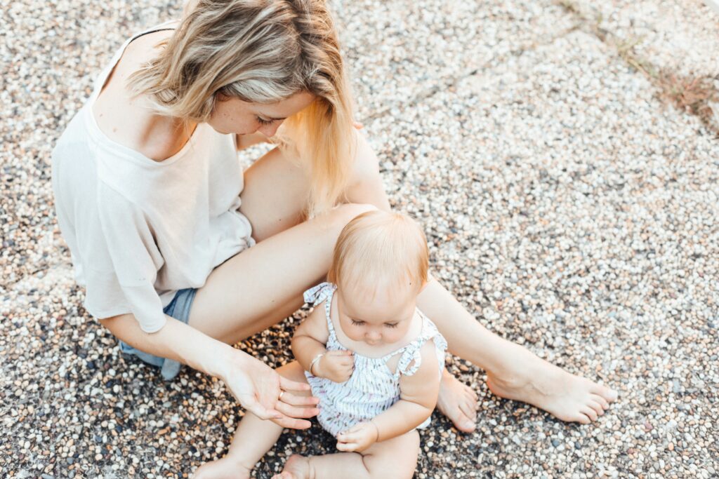 Mom playing with her baby outside.