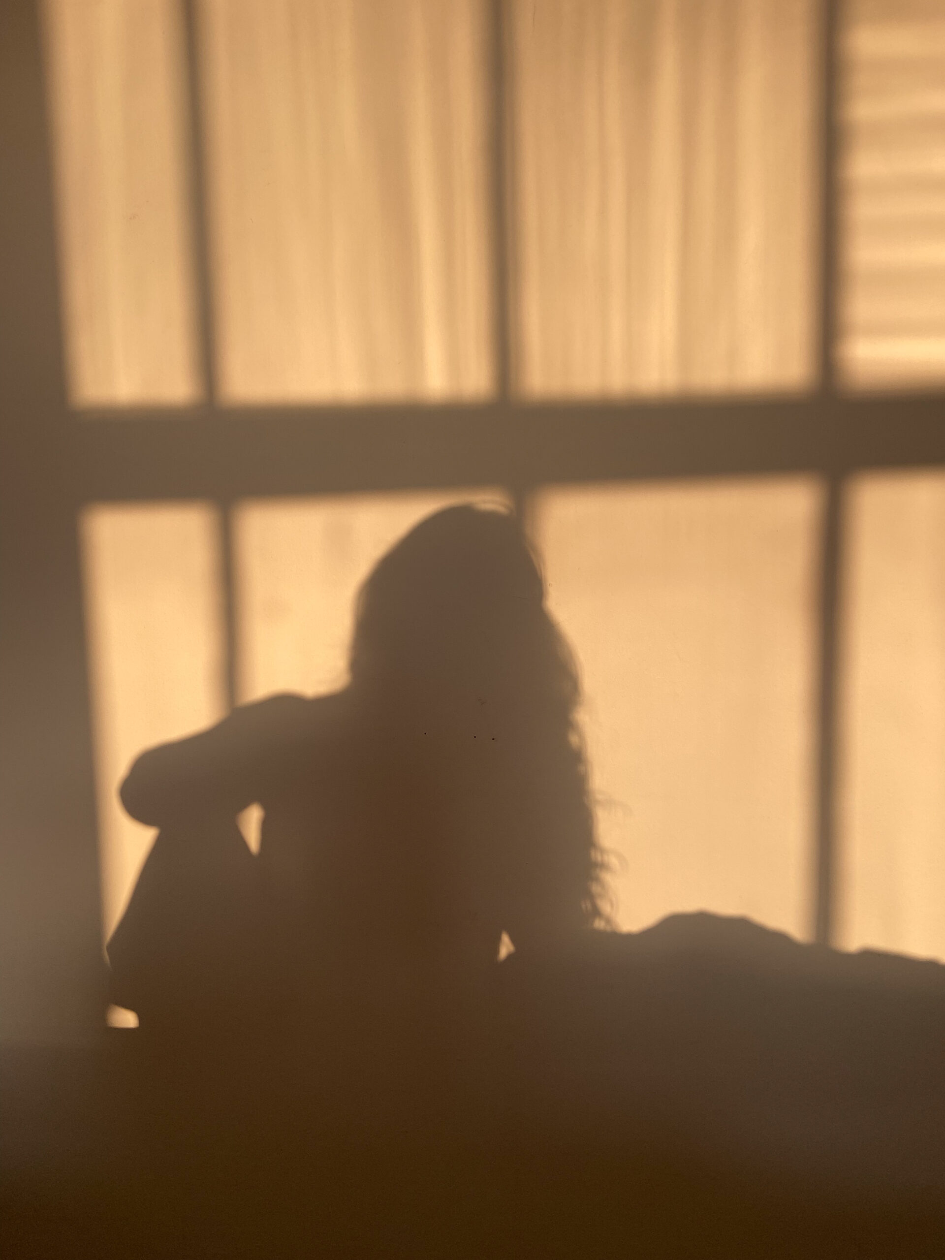 Woman in the reflection on the wall.