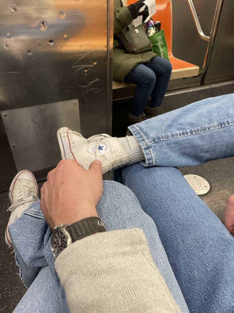 Couple in jeans on subway together.