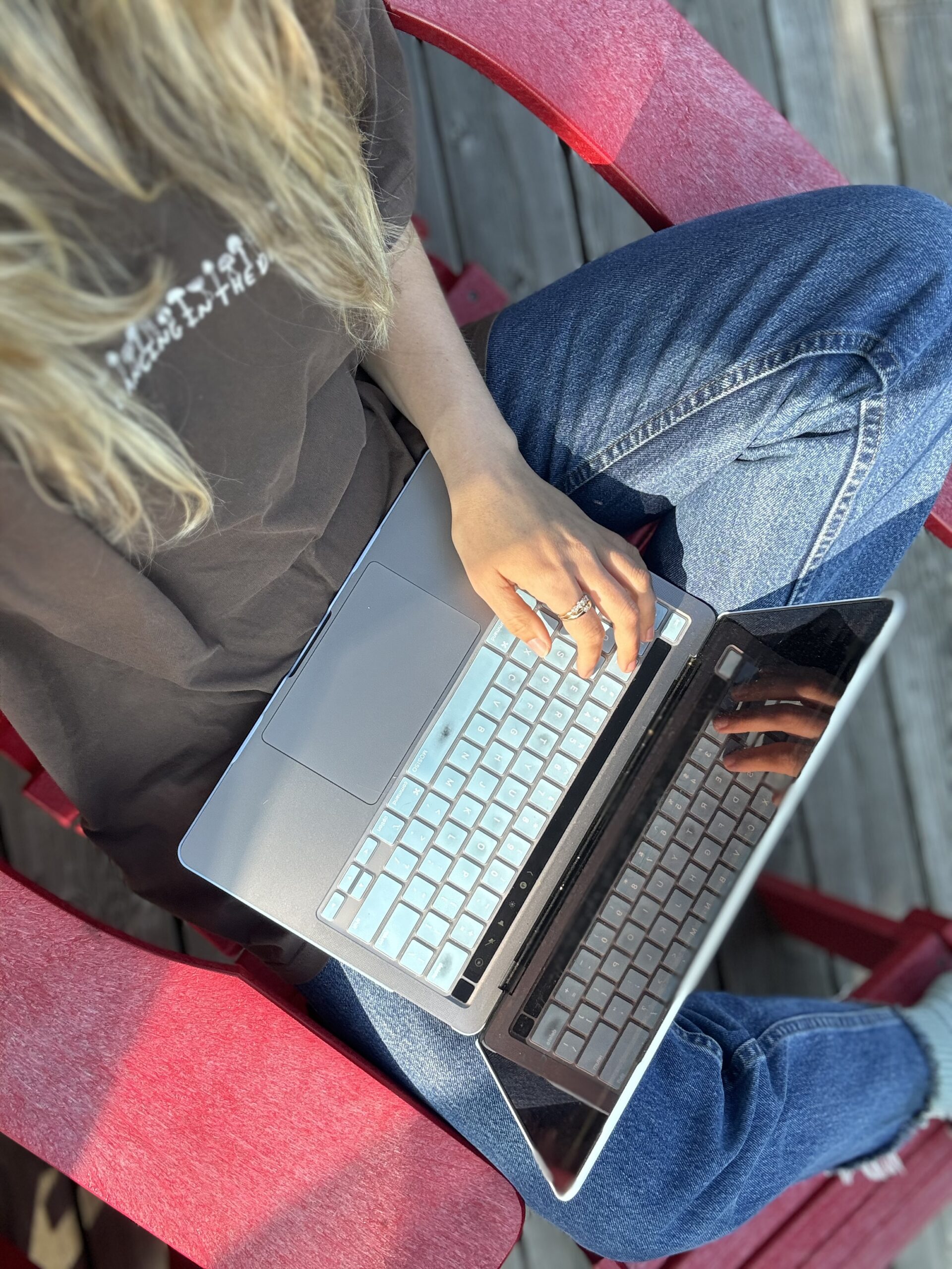 College student on her laptop doing work outside.