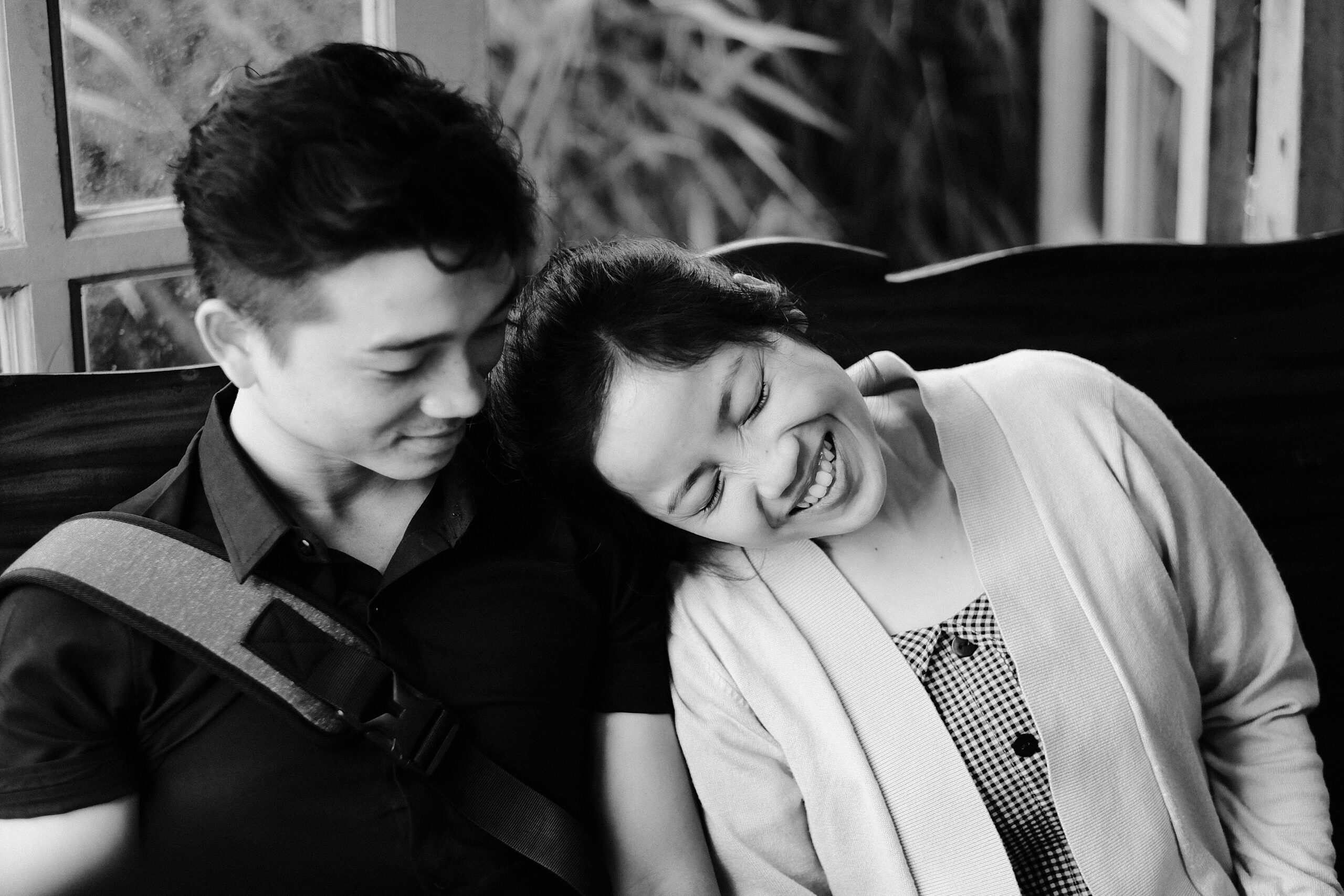 Couple leaning on each other smiling.