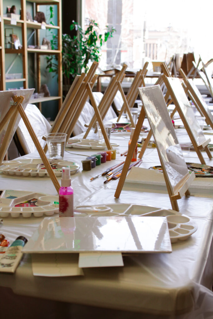 Table full of supplies for a painting class. 