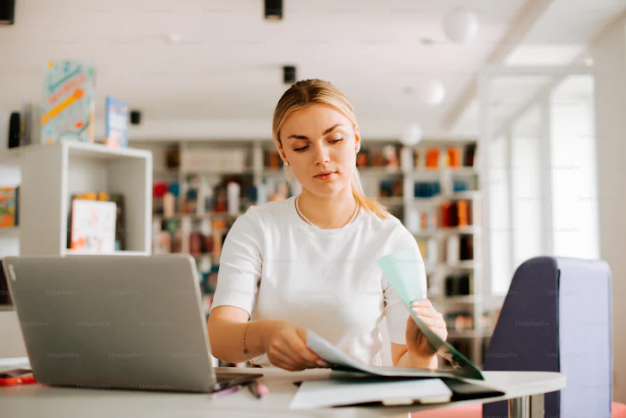 Girl doing work on her computer. 