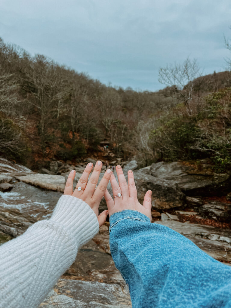 Engaged couple showing their rings.